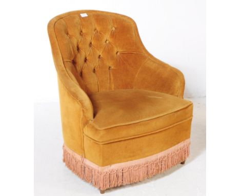 An early 20th century French manner boudoir button back lounge chair / armchair. The chair upholstered in yellow fabric, with