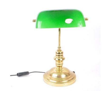 A vintage mid 20th century bankers table top desk lamp light. With a hand blown green glass light shade metal curved support 