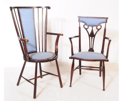 Two early 20th century Arts and Crafts beech wood ebonised armchairs. The chairs each having blue fabric upholstery. One chai