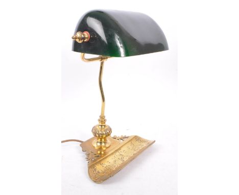 A vintage 20th Century desktop bankers lamp light having green glass shade upon a metal brass stem support with engraved pen 