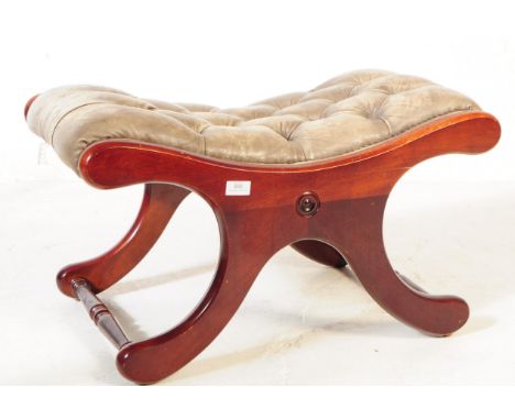 An early 20th century mahogany framed chesterfield style slipper / footstool. The footstool featuring a mahogany x frame, uni