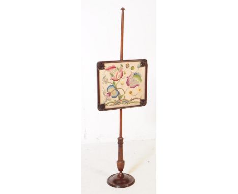 A Victorian 19th century mahogany fire screen pole. With tapering central column with glazed panel with flower needlepoint sa