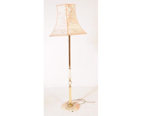 A 20th century Hollywood Regency manner Onyx and Brass style floor standing lamp with shade. The lamp stood on a rounded onyx