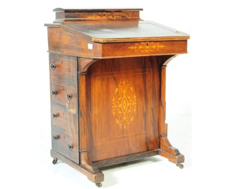 An Edwardian walnut inlaid davenport writing desk. Of rectangular form with sloping writing desk with hinged lid opening to r