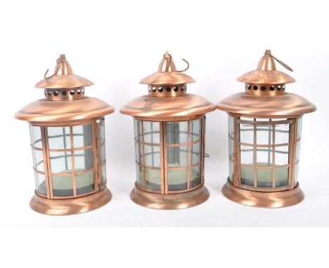 A set of three large 20th Century copper and glass porch lanterns / lights of circular form having copper square design and h