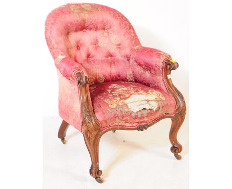 A Victorian 19th century lounge armchair. Having an arched top with button back rest on padded elbow rests, overstuff seat wi