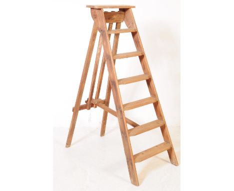 A vintage 20th century wooden pine step ladder. Having an A frame with folding mechanism. Measures approx. 130cm tall.&nbsp;