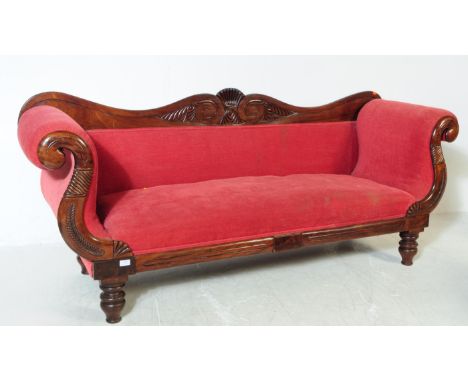 A Victorian 19th century mahogany three seater sofa / settee. With arched curved backrest with carved detail to centre. With 