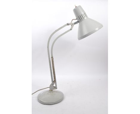 A mid Century metal industrial table top lamp having grey ground spring loaded support arm upon a circular weighted base with