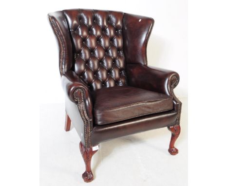Chesterfield style - A 20th Century brown leather Chesterfield manner wingback armchair. Raised on cabriole legs to front wit