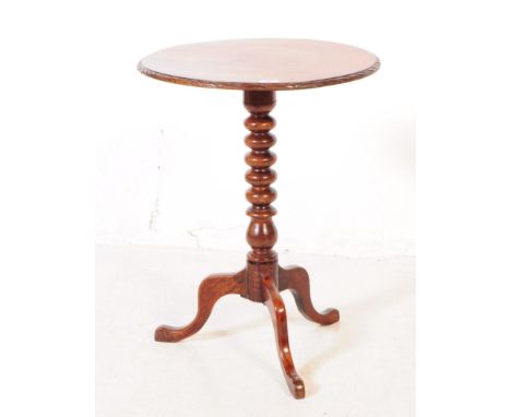 A George III mahogany occasional side table. Of circular form with carved chamfered edge, bobbin turned central column on tri