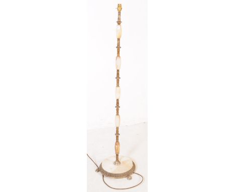 A vintage circa 1970s onyx and brass floor standing standard lamp having oval onyx sections interspersed by ornate brass divi