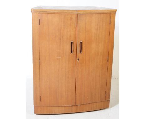 Turnidge of London - A mid 20th century teak cocktail drinks cabinet. With twin hinged doors to front opening to reveal a fit