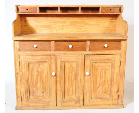 A 19th century Victorian pine sideboard dresser. The sideboard raised on a plinth base below two cupboard doors separated to 