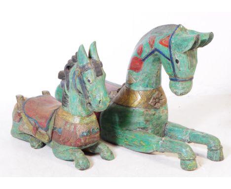 Two mid 20th century Folk Art theatre production props carved solid wooden horse figures. With hand painted decoration, lying