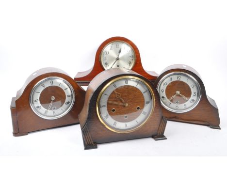 A collection of four Art Deco Napoleon shaped mantel clocks all with Westminster chime movement, having silver face, two with