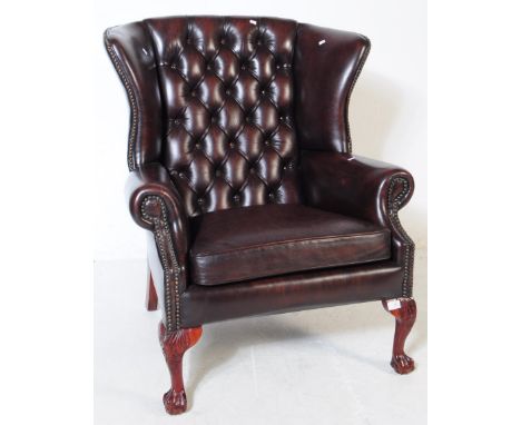 Chesterfield style - A 20th Century brown leather Chesterfield manner wingback armchair. Raised on cabriole legs to front wit