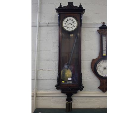 An ebonised and rosewood Vienna wall clock, with enamelled dial, the case with applied roundels, 115cm