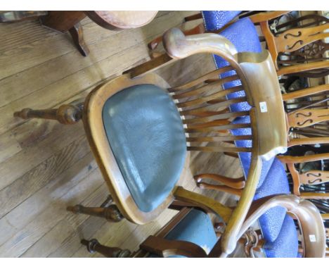 A 1920s beech office chair, the rail back over a padded seat on turned tapering legs joined by stretchers