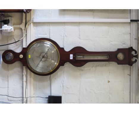 An early 19th century mahogany banjo barometer with ebony stringing, hygrometer, thermometer, spirit level and silvered dial,