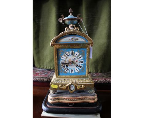 A French ormolu and porcelain mounted mantel clock, the blue ground panels depicting exotic birds, the twin train movement st