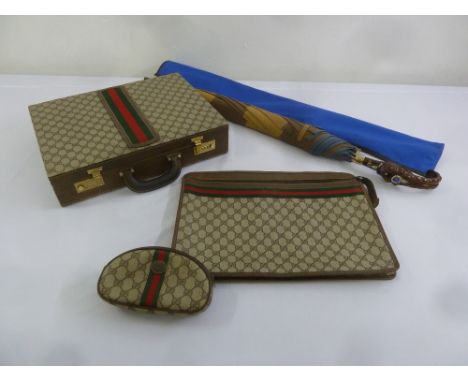 A vintage Gucci attaché case, messenger bag, sun glass holder and a decorative umbrella