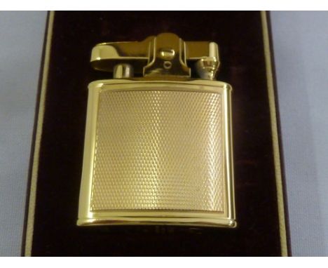 A Ronson 9ct gold engine turned cigarette lighter in original fitted case