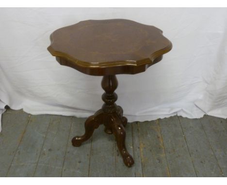 A mahogany side table with shaped circular top on tripod base