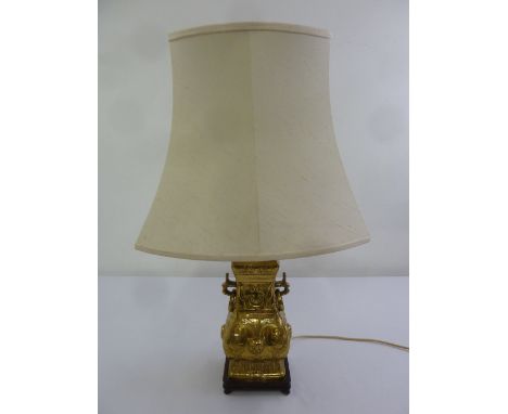 An Oriental style brass lamp stand on hardwood base with silk shade