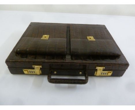 A vintage crocodile skin attaché case with gilded metal locks and clasps