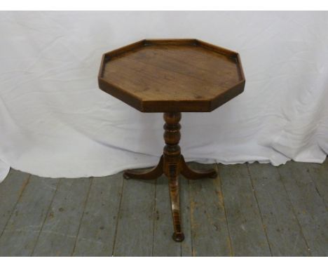 A mahogany hexagonal galleried wine table on tripod base