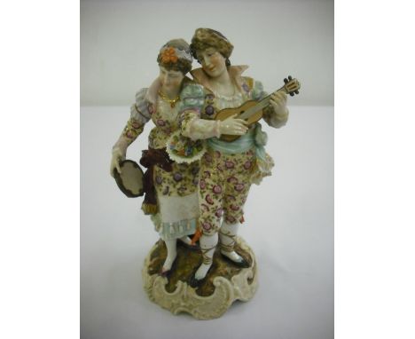 A Continental figural group of a lady and gentleman playing musical instruments, marks to the base