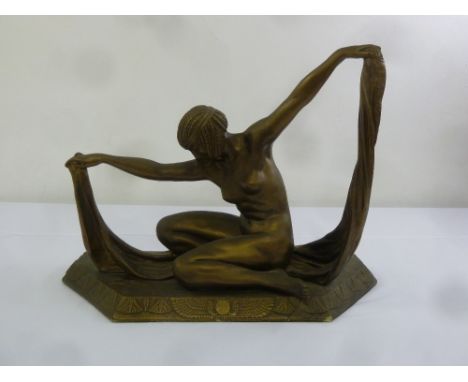 An Art Deco bronzed figurine of a lady on raised hexagonal base, signed to the base, 39cm (h)