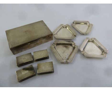 A quantity of silver to include an engine turned cigarette box, four matching silver ashtrays and four silver matchbox holder