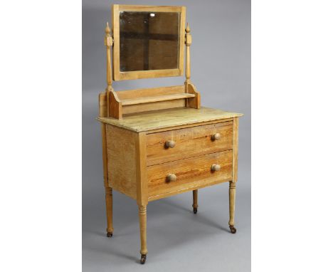 A pine small dressing chest with a rectangular seeing mirror to the stage back, fitted two long drawers, &amp; on short turne