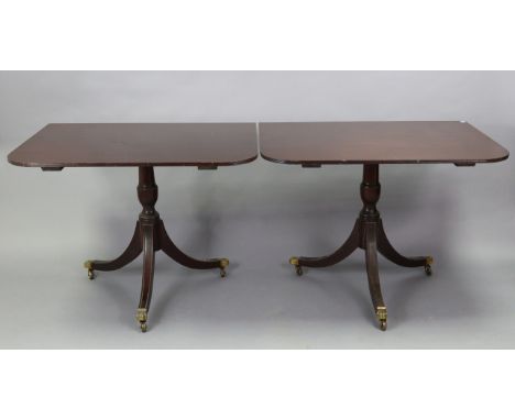 A regency-style mahogany twin-pedestal dining table with rounded corners to the rectangular top, with centre leaf, &amp; on v