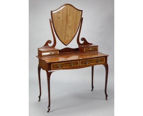 A 19th century style inlaid-mahogany serpentine front dressing table with a shield-shaped swing mirror to the stage back, fit