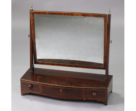 A Georgian mahogany swing toilet mirror with rectangular plate on fluted supports &amp; bow-front base fitted three drawers w