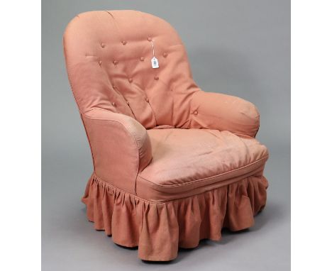 A Victorian buttoned-back easy chair upholstered pink material, on short turned front legs with ceramic castors (requires re-
