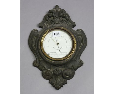 An early 20th century wall barometer, the 4¼” white enamel dial signed “T. DOWNIE, HAMBURG”, in black-finish metal case, 14” 