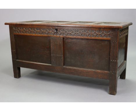 A late 17th century oak coffer, with hinged lift-lid, carved frieze &amp; a two-panel front (restored), 54” wide x 27” high x
