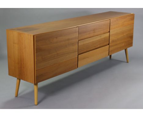 A BoConcept teak finish sideboard, fitted three long drawers to centre flanked by a cupboard either end enclosed by panel doo