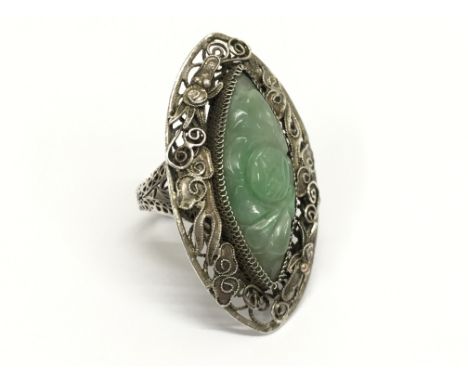 A Chinese silver and jade ring of elongated oval form. Ring size approx O, total weight approximately 6 grams.