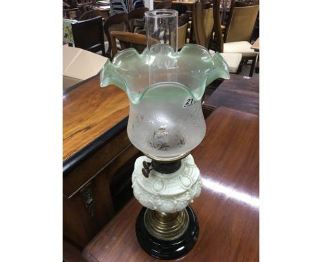 A Victorian oil lamp with green milk glass and green glass shade