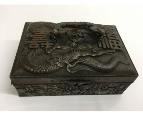 A Japanese type bronzed ring box decorated in relief with a dragon, approx 7x11.5cm
