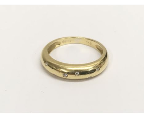 A ladies 18ct yellow gold ring inset sporadically with seven white stones, approx weight 4 grams.