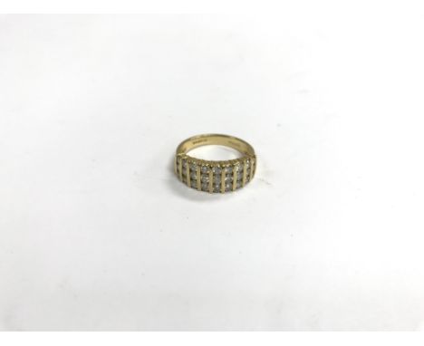 An 18ct gold ring set with vertical rows of diamonds. Weight approx 5g, size approx N/O.