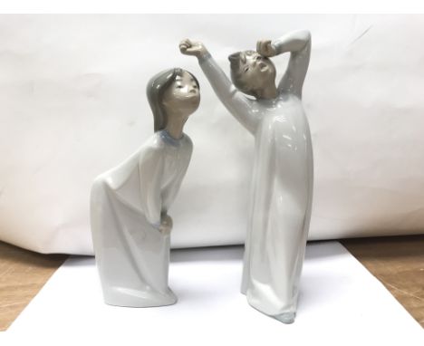 A pair of Lladro figures of bed time.