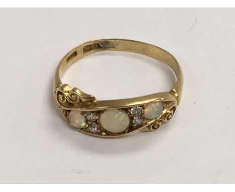 An 18ct gold Diamond and opal set ring. Ring size S.