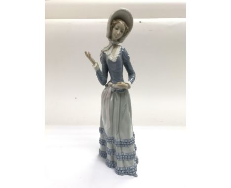 A Lladro figure of a lady (missing parasol).